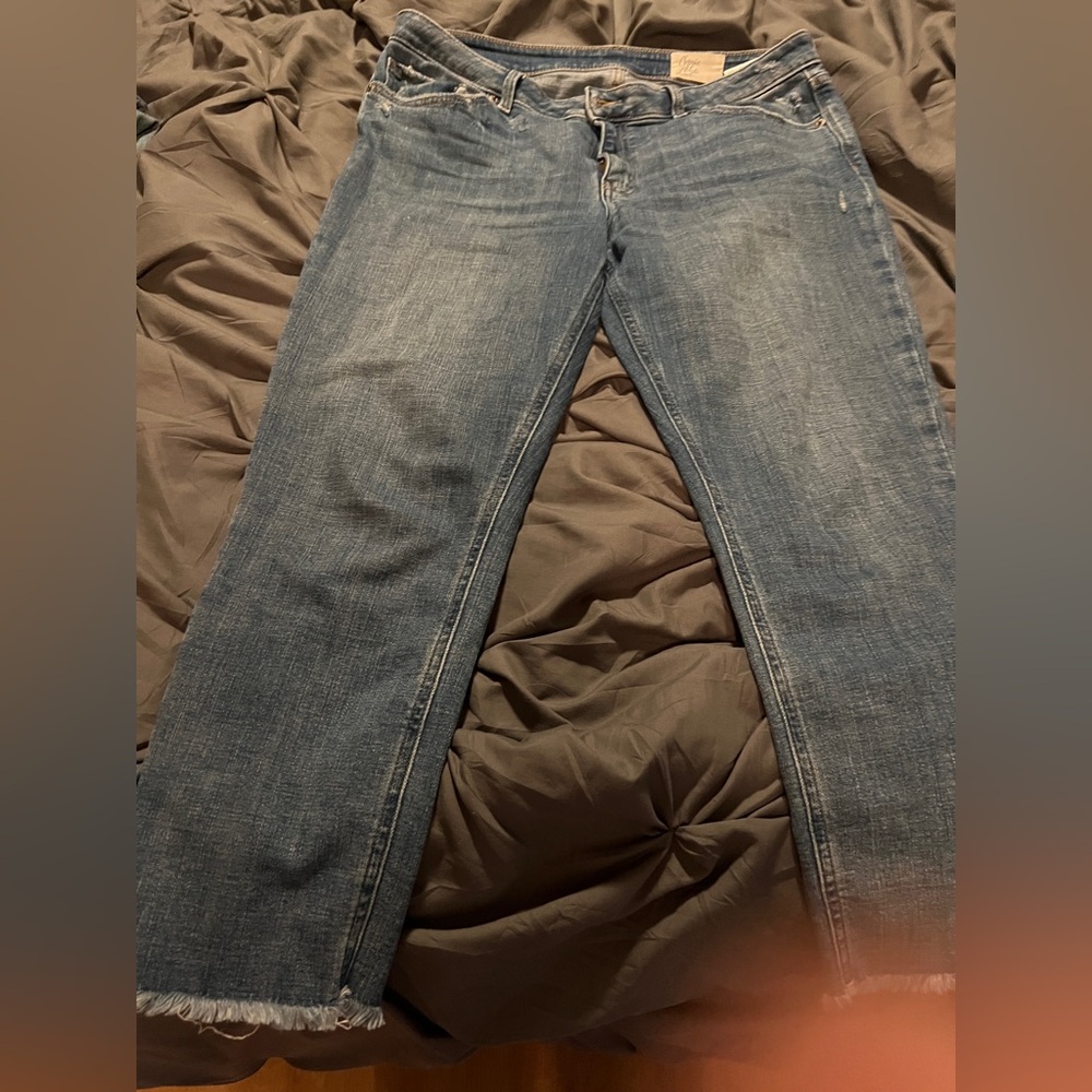 Women's Blue Jeans, ankle length with intention frayed hem for distressed look.